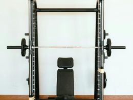 Power racks are a versatile tool for strength training, offering safety and stability for lifting heavy weights. This guide explores key exercises to maximise your power rack workouts. Understanding Power Racks A power rack is a cage-like structure with adjustable uprights and safety features like spotter arms. These features allow you to lift with confidence, pushing yourself to build strength and muscle. Benefits of Power Racks Safety: Safety pins catch the barbell if you fail a rep, minimising injury risk. Stability: The rack provides a stable platform for exercises like squats and bench press. Versatility: Power racks often have pull-up bars, dip bars, and other attachments for various exercises. Top 6 Power Rack Exercises Squats: The king of lower body exercises, squats target quads, hamstrings, glutes, and calves. The power rack allows safe squatting with heavy weights. Enhance your power rack workouts with squat variations: Goblet Squats: Hold a dumbbell or kettlebell in front of your chest to target quads, glutes, and core. Front Squats: Emphasise quads and core by resting the barbell on the front of your shoulders. Bulgarian Split Squats: Target quads, glutes, hamstrings for improved balance and stability. Pistol Squats: Strengthen quads, glutes, core with this balance-demanding variation. Bench Press: A classic upper body exercise, the bench press targets the chest, shoulders, and triceps. The power rack provides stability for lifting heavier weights. The bench press targets chest, shoulders, and triceps. Using a power rack for bench press ensures safety, stability, and allows for lifting heavier weights to build upper body strength. Steps for bench press in a power rack: Set safety pins just below chest level. Position the barbell at arm's length. Lie down so the bar is above your eyes. Lower the bar to your chest. Push back up, fully extending arms. Repeat for desired reps. Maintain proper form and technique to prevent injury and maximize effectiveness while performing the bench press exercise. Pull-Ups/Chin-Ups: These compound exercises target the back, biceps, and shoulders, and improve core stability. The power rack allows for proper form and technique. Pull-ups and chin-ups target the back, biceps, and shoulders, engaging core muscles for strength and stability. Use a power rack for stability and focus on form: Set up the pull-up bar at the right height. Grab the bar with an overhand (pull-ups) or underhand grip (chin-ups). Hang with arms extended and core engaged. Pull up until your chin clears the bar. Slowly lower back down. Repeat for desired reps. Overhead Press: This exercise strengthens shoulders and triceps. The power rack allows for a greater range of motion and provides safety. The overhead press, or military press, targets shoulder and tricep muscles. It's key for upper body strength and stability. Using a power rack enhances range of motion and safety. To do the overhead press in a power rack: Set safety pins just below shoulder level. Place the barbell at shoulder height. Stand in front of the bar, grip it slightly wider than your shoulders. Lift the bar overhead, arms fully extended. Lower the bar to shoulder level, elbows slightly bent. Repeat for desired reps. Incorporating this exercise boosts shoulder strength and overall upper body power. 5. Barbell Rows: Barbell rows target the back muscles, promoting overall development. The power rack allows for safe and controlled execution. Barbell rows target back muscles for complete development, engaging lats, rhomboids, traps, biceps, forearms, and core. Set up the bar in a power rack at the right height. Stand with feet shoulder-width apart, hinge at the hips to grab the bar with an overhand grip, and maintain a neutral spine. Pull the bar towards your lower chest while keeping your back straight and squeezing your shoulder blades together. Lower the bar in a controlled manner and repeat. Focus on maintaining proper form and gradually increase weight as you get stronger. 6. Deadlifts: Deadlifts are a full-body exercise that tests overall strength. The power rack allows for a safe setup and easy loading/unloading of weights. For safe deadlifts on a power rack: Adjust J-hooks or uprights to mid-shin level. Place the barbell aligned with J-hooks. Approach bar with shoulder-width stance, flat back. Grasp bar just outside shoulder-width. Push through heels to lift the bar, maintaining form. Lower bar in controlled manner, touch floor between reps. Advanced Power Rack Exercises: Once you've mastered the foundational exercises, the power rack opens doors to more targeted movements for sculpted physiques and increased strength. Pin Squats: Set the safety pins just below your sticking point in a squat. This eliminates momentum and forces you to build power through the entire movement, strengthening specific weaknesses. Safety Squat Variations: Utilise the safety pins for front squats, overhead squats, or Bulgarian split squats. These variations target different muscle groups while maintaining safety with heavy weights. Incline/Decline Bench Press: Adjust the rack benches for incline or decline variations of the bench press. This emphasises the upper or lower pec muscles, respectively, for a more complete chest workout. Landmine Exercises: Attach a barbell landmine attachment to the rack. This allows for unique exercises like single-arm rows, shoulder presses, and rotational movements that challenge core stability and improve overall athleticism. Power Rack Training Tips: Warm-up: Before lifting heavy weights, perform dynamic stretches and light weight exercises to prepare your muscles and joints. Progression: Gradually increase weight, sets, and reps as you get stronger. Don't sacrifice form for heavier weights. Mind-Muscle Connection: Focus on the targeted muscle group during each exercise for optimal results. Rest Periods: Allow sufficient rest (usually 1-3 minutes for compound lifts) between sets to recover and maintain proper form. Form Check: Use a mirror or video recordings to ensure proper form and avoid injuries. By incorporating these exercises, advanced variations, and training tips, you can transform your power rack workouts into a well-rounded program for building strength, muscle mass, and overall fitness. Remember, consistency and proper technique are key to unlocking the full potential of power rack training. Conclusion Power rack exercises can significantly enhance your strength training. Master the proper techniques for these exercises to maximise your workouts and achieve your fitness goals. Remember to focus on form and control to get the most out of your power rack training.