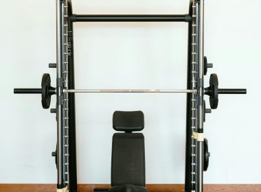 Power racks are a versatile tool for strength training, offering safety and stability for lifting heavy weights. This guide explores key exercises to maximise your power rack workouts. Understanding Power Racks A power rack is a cage-like structure with adjustable uprights and safety features like spotter arms. These features allow you to lift with confidence, pushing yourself to build strength and muscle. Benefits of Power Racks Safety: Safety pins catch the barbell if you fail a rep, minimising injury risk. Stability: The rack provides a stable platform for exercises like squats and bench press. Versatility: Power racks often have pull-up bars, dip bars, and other attachments for various exercises. Top 6 Power Rack Exercises Squats: The king of lower body exercises, squats target quads, hamstrings, glutes, and calves. The power rack allows safe squatting with heavy weights. Enhance your power rack workouts with squat variations: Goblet Squats: Hold a dumbbell or kettlebell in front of your chest to target quads, glutes, and core. Front Squats: Emphasise quads and core by resting the barbell on the front of your shoulders. Bulgarian Split Squats: Target quads, glutes, hamstrings for improved balance and stability. Pistol Squats: Strengthen quads, glutes, core with this balance-demanding variation. Bench Press: A classic upper body exercise, the bench press targets the chest, shoulders, and triceps. The power rack provides stability for lifting heavier weights. The bench press targets chest, shoulders, and triceps. Using a power rack for bench press ensures safety, stability, and allows for lifting heavier weights to build upper body strength. Steps for bench press in a power rack: Set safety pins just below chest level. Position the barbell at arm's length. Lie down so the bar is above your eyes. Lower the bar to your chest. Push back up, fully extending arms. Repeat for desired reps. Maintain proper form and technique to prevent injury and maximize effectiveness while performing the bench press exercise. Pull-Ups/Chin-Ups: These compound exercises target the back, biceps, and shoulders, and improve core stability. The power rack allows for proper form and technique. Pull-ups and chin-ups target the back, biceps, and shoulders, engaging core muscles for strength and stability. Use a power rack for stability and focus on form: Set up the pull-up bar at the right height. Grab the bar with an overhand (pull-ups) or underhand grip (chin-ups). Hang with arms extended and core engaged. Pull up until your chin clears the bar. Slowly lower back down. Repeat for desired reps. Overhead Press: This exercise strengthens shoulders and triceps. The power rack allows for a greater range of motion and provides safety. The overhead press, or military press, targets shoulder and tricep muscles. It's key for upper body strength and stability. Using a power rack enhances range of motion and safety. To do the overhead press in a power rack: Set safety pins just below shoulder level. Place the barbell at shoulder height. Stand in front of the bar, grip it slightly wider than your shoulders. Lift the bar overhead, arms fully extended. Lower the bar to shoulder level, elbows slightly bent. Repeat for desired reps. Incorporating this exercise boosts shoulder strength and overall upper body power. 5. Barbell Rows: Barbell rows target the back muscles, promoting overall development. The power rack allows for safe and controlled execution. Barbell rows target back muscles for complete development, engaging lats, rhomboids, traps, biceps, forearms, and core. Set up the bar in a power rack at the right height. Stand with feet shoulder-width apart, hinge at the hips to grab the bar with an overhand grip, and maintain a neutral spine. Pull the bar towards your lower chest while keeping your back straight and squeezing your shoulder blades together. Lower the bar in a controlled manner and repeat. Focus on maintaining proper form and gradually increase weight as you get stronger. 6. Deadlifts: Deadlifts are a full-body exercise that tests overall strength. The power rack allows for a safe setup and easy loading/unloading of weights. For safe deadlifts on a power rack: Adjust J-hooks or uprights to mid-shin level. Place the barbell aligned with J-hooks. Approach bar with shoulder-width stance, flat back. Grasp bar just outside shoulder-width. Push through heels to lift the bar, maintaining form. Lower bar in controlled manner, touch floor between reps. Advanced Power Rack Exercises: Once you've mastered the foundational exercises, the power rack opens doors to more targeted movements for sculpted physiques and increased strength. Pin Squats: Set the safety pins just below your sticking point in a squat. This eliminates momentum and forces you to build power through the entire movement, strengthening specific weaknesses. Safety Squat Variations: Utilise the safety pins for front squats, overhead squats, or Bulgarian split squats. These variations target different muscle groups while maintaining safety with heavy weights. Incline/Decline Bench Press: Adjust the rack benches for incline or decline variations of the bench press. This emphasises the upper or lower pec muscles, respectively, for a more complete chest workout. Landmine Exercises: Attach a barbell landmine attachment to the rack. This allows for unique exercises like single-arm rows, shoulder presses, and rotational movements that challenge core stability and improve overall athleticism. Power Rack Training Tips: Warm-up: Before lifting heavy weights, perform dynamic stretches and light weight exercises to prepare your muscles and joints. Progression: Gradually increase weight, sets, and reps as you get stronger. Don't sacrifice form for heavier weights. Mind-Muscle Connection: Focus on the targeted muscle group during each exercise for optimal results. Rest Periods: Allow sufficient rest (usually 1-3 minutes for compound lifts) between sets to recover and maintain proper form. Form Check: Use a mirror or video recordings to ensure proper form and avoid injuries. By incorporating these exercises, advanced variations, and training tips, you can transform your power rack workouts into a well-rounded program for building strength, muscle mass, and overall fitness. Remember, consistency and proper technique are key to unlocking the full potential of power rack training. Conclusion Power rack exercises can significantly enhance your strength training. Master the proper techniques for these exercises to maximise your workouts and achieve your fitness goals. Remember to focus on form and control to get the most out of your power rack training.