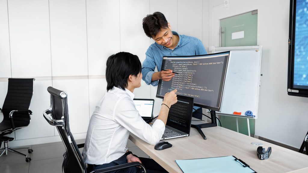Engineers reviewing code on a monitor: Checks Product Teams Should Run Before Plugging In a Public-Record API