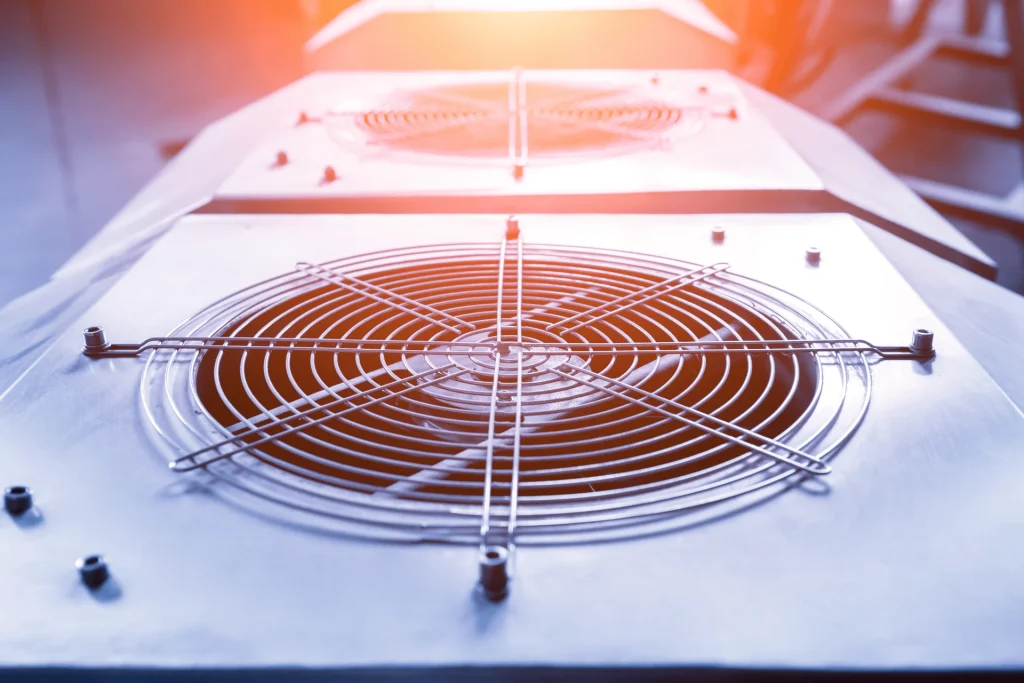 Commercial HVAC condenser fan units on a rooftop plant deck