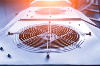 Commercial HVAC condenser fan units on a rooftop plant deck