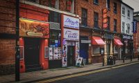 Row of independent shopfronts on a red brick high street