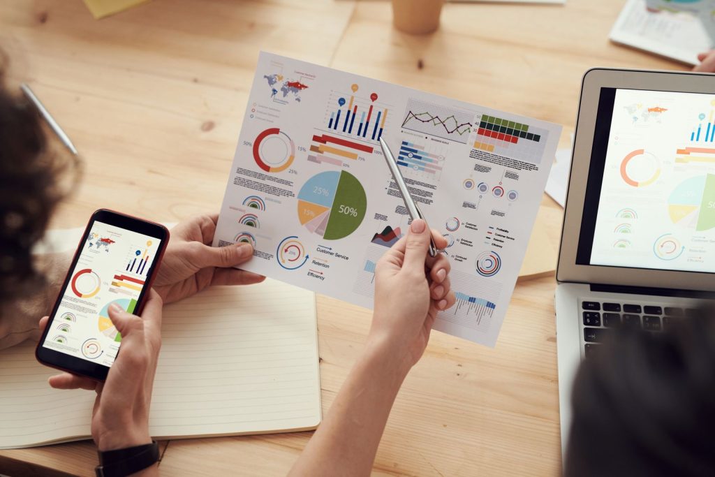 Niche Track Records Set Top SEO Agencies Apart From the Average: marketing specialists reviewing SEO and campaign analytics charts at a desk